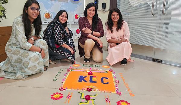Employees creating Rangoli in office